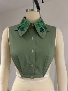 This fake shirt features machine embroidered ivy leaves on the shaped collar. Made to sit under the bust, the pleats and adjustable side elastics allow it to sit comfortably without riding up, giving you more versatile styling options with a deep neck jumper or cardigan on top. Perfect for layering.  Made to order using pre-washed green  100% cotton poplin fabric and polyester embroidery thread. Available in 15-16-17-18-19 inch collar sizes and adjustable range waist sizes please choose your req Fun Collared Shirts, Green Cotton Shirt With Floral Embroidery, Green Cotton Tops With Machine Embroidery, Fitted Green Tops With Floral Embroidery, Green Fitted Top With Floral Embroidery, Green Embroidered Collared Shirt, Embroidered Cotton Collar Tops, Green Cotton Top With Floral Embroidery, Embroidered Green Cotton Shirt