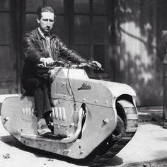 a man riding on the back of a motorcycle with a side car attached to it