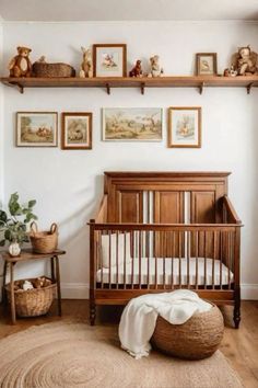 a baby's room with pictures on the wall and a crib in the corner