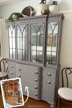 an old china cabinet painted gray with gold trim