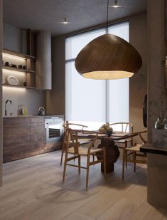 a dining room table with chairs and a light hanging from the ceiling