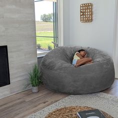 a person laying on a bean bag chair in a living room