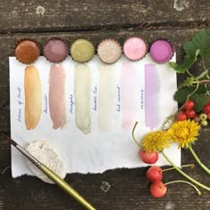 the swatches are all different colors and there is a flower on the table next to them