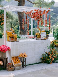 an outdoor wedding with flowers and fruit on the table in front of it is instagramted