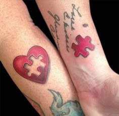 two people with matching tattoos on their arms holding each other's hands and one has a puzzle piece in the shape of a heart