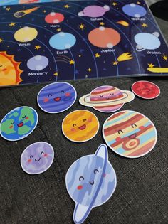 there are many stickers on the back of a couch that have different faces and planets