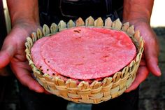 a person holding a basket with food in it