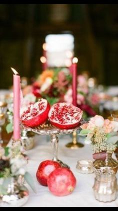 the table is set with candles and fruit