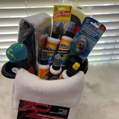 a car care basket is sitting on a white furnishing next to a window