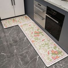 two kitchen mats on the floor in front of an oven