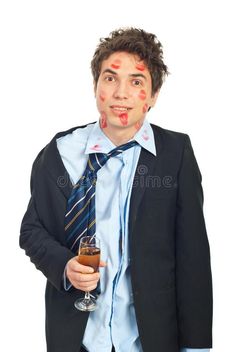 a man in a suit and tie holding a drink with his face painted on it