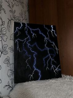 a black and white painting with lightning in the sky above it on a fluffy rug