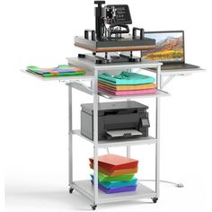 a computer desk with a printer and other office supplies on top of it, along with several colored folders