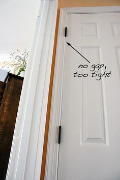 a white door with the words no gap too tight on it and an arrow pointing up