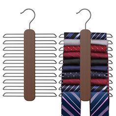 three ties hang on clothes racks next to each other, one with a tie bar