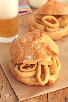 two sandwiches sitting on top of a wooden cutting board