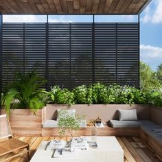 an outdoor living area with wooden furniture and plants on the roof terrace, surrounded by greenery