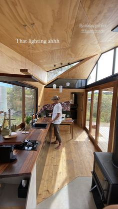 a man standing in the middle of a kitchen next to an open floorplan