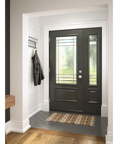 a black front door with two coats hanging on the hooks and a rug underneath it