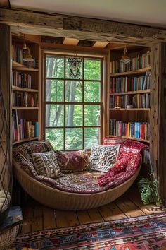 a living room filled with furniture and bookshelves next to a window covered in lots of books