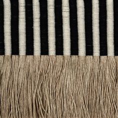 black and white striped rug with fringes on it's edges, close up