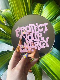 a person holding up a sticker with the words project your energy written on it