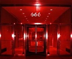 the entrance to an office building with red lights