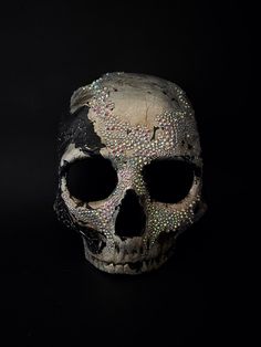 a human skull with lots of colored sprinkles on it's face