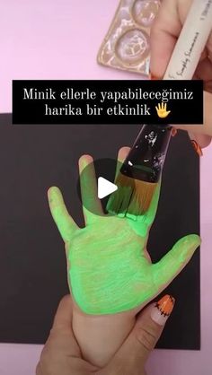 someone is painting their hand with neon green paint