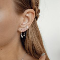 This pair of huggie earrings is made from 925 sterling silver and features a smooth hoop with a small flower (a floweret) pendant hanging from their lower edge, embellished with 6 tiny zirconia stones. They open and close with a hinged opening, also on the lower edge, and have a thin earpiece that threads comfortably through the earlobe. A timeless, graceful design that will work with a huge array of styles.  Also available in 18k gold plated sterling silver: https://www.etsy.com/listing/1067338248/floweret-huggie-earrings-gold-plated 🎁 Packaging: Beautifully packed in a box, ready for gifting. 🏷️ This product is made of sterling silver -- easily recognizable by its '925' stamp of authenticity. It is also hypoallergenic, making it suitable for people with sensitive or irritable skin. We Slogan Tees, Huggie Earrings Silver, Daisy Studs, Slip Dresses, Small Earrings Studs, Natural Pearl, Huggie Earrings, Pearl Size, Earrings Sterling Silver