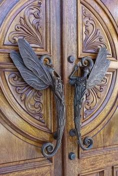 an ornate wooden door with two dragon handles