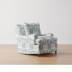 a blue and white chair sitting on top of a hard wood floor