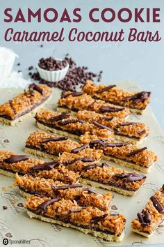 chocolate covered granola coconut bars are arranged on a sheet of parchment paper and ready to be eaten