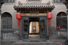 the entrance to an old building with red lanterns