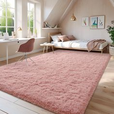 a bedroom with a pink rug on the floor