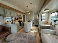 a living area with couches, chairs and kitchen