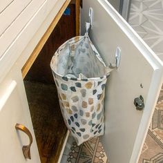 an open door with a bag hanging from it's handle on the bottom half