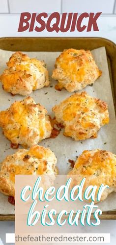 cheddar biscuits on a baking sheet with text overlay