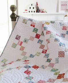 a bed with a quilt on top of it