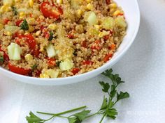 a white bowl filled with rice and veggies on top of a table next to an apple