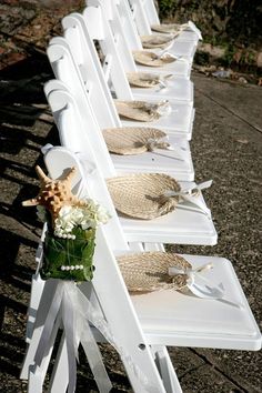 a row of white chairs sitting next to each other