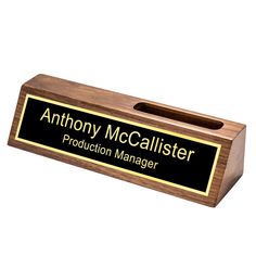 an award plaque with the words anthony mccallister production manager in gold and black