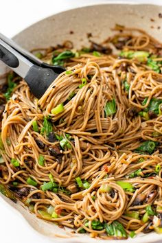 a skillet filled with noodles and vegetables