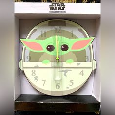 a clock with the face of baby yoda on it