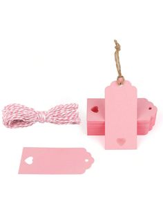 two pink tags, one with a bow tie and the other has a tag attached to it