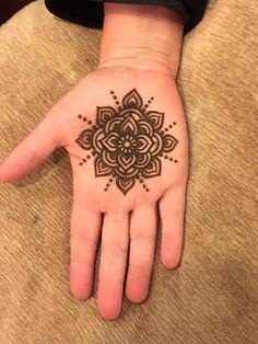 a person's hand with a tattoo on it