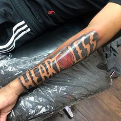 a man's arm with the word fearless on it and an image of a heart