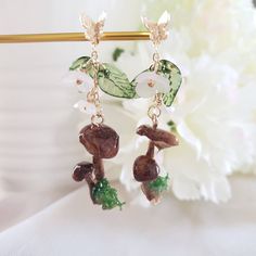 "woodland earrings  real mushroom wrapped with resin, acrylic leaf and flowers, gold plated hooks length: about 2\" Contains small parts. Use caution when giving to young children less than Age 3 Please keep them away from moisture. If you have any questions, please feel free to contact me. Thanks :)" Purple Dangle Earrings, Woodland Earrings, Woodland Jewelry, Mushroom Earrings, Resin Acrylic, Woodland Fairy, Fabric Flowers Diy, Fall Earrings, Fall Jewelry