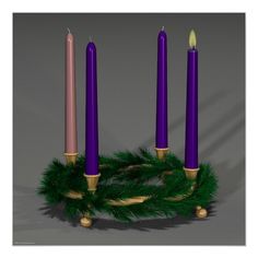 three purple candles sitting on top of a wreath with green garland around it's sides