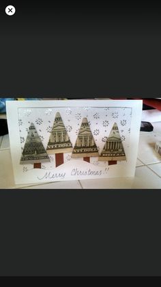 a card with three christmas trees on it